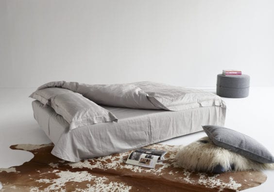 grey bed, rug and ottoman