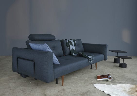 dark blue sofa with cushion and throw