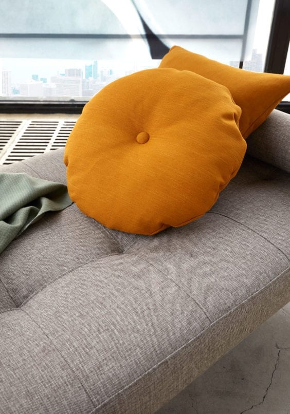 grey daybed with orange cushions